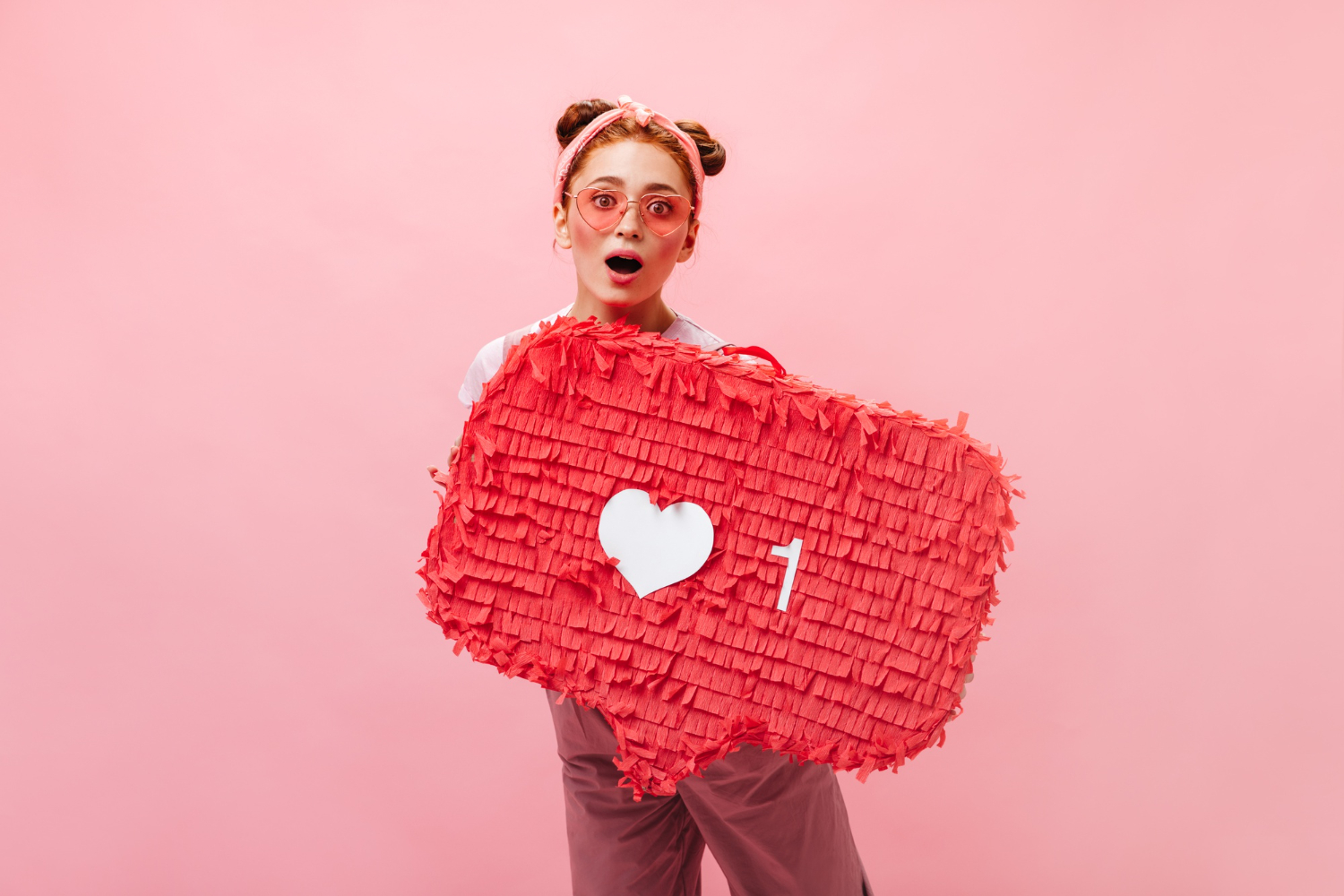 Reviews on Plano Woman with a red heart-shaped piñata on a pink background